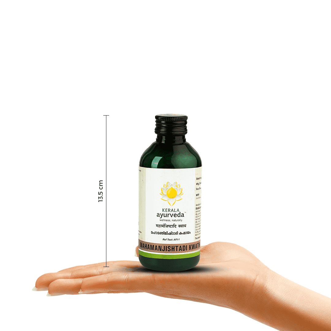 A hand holding a bottle of Kerala Ayurveda Mahamanjishtadi Kwath, with a measurement indicator showing its height as 13.5 cm. The product name and brand logo are clearly visible on the label. – Kerala Ayurveda India