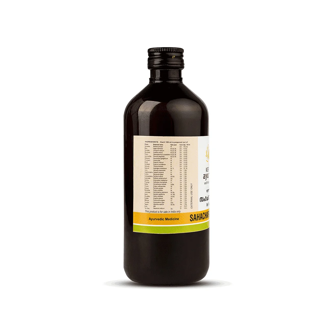 Side-label view of Kerala Ayurveda Sahacharadi Thailam glass bottle showing full herbal ingredients list and dosage panel, underscoring its authentic Ayurvedic neuromuscular massage oil formula – Kerala Ayurveda India