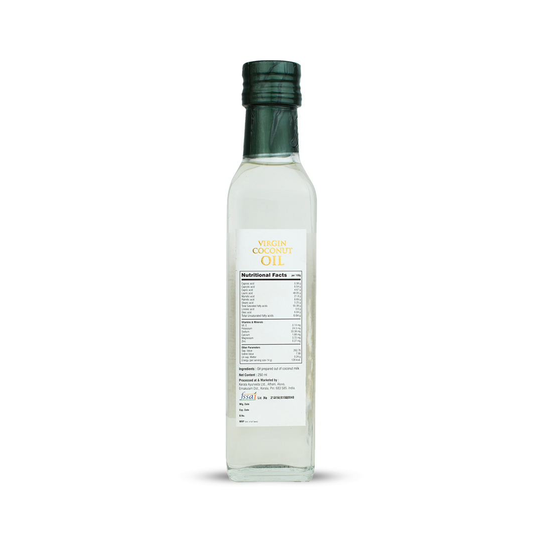 Back view of the clear glass bottle of Kerala Ayurveda Virgin Coconut Oil, showing detailed Nutritional Facts per 100g, Net Content (250 ml), and FSSAI license number. – Kerala Ayurveda India